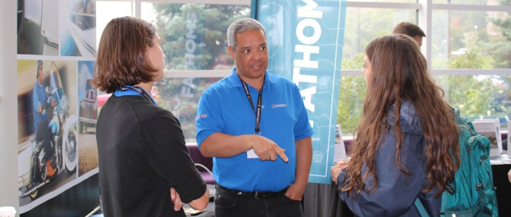 Michigan Tech students talk to a business representative at Grand Traverse Region Day