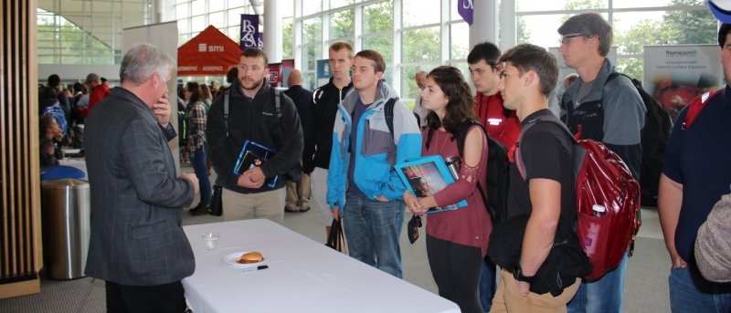 Michigan Tech students talk to a business represenative at Grand Traverse Region Day