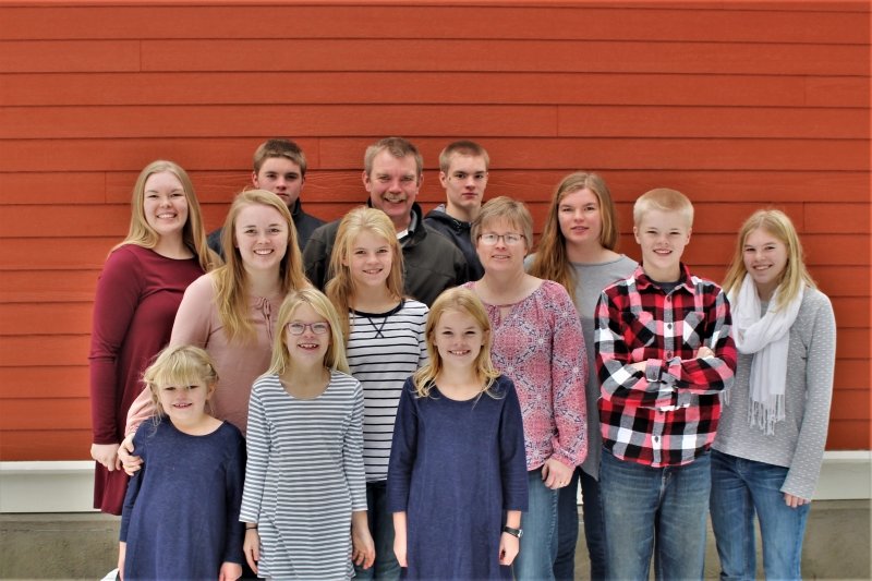 family photo in front of a barn