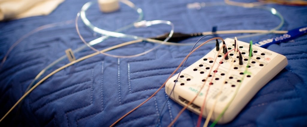 electronic device with wires on a bed