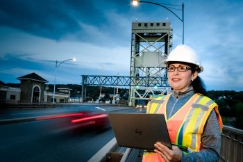 woman in safety gear standing next to Houghton Lift Bridge