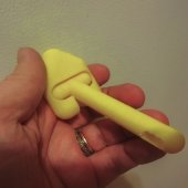 yellow plastic cylinder with ball joint and crevice