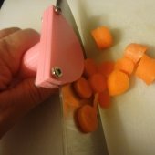 orange plastic cap that sits over the dull edge of a knife