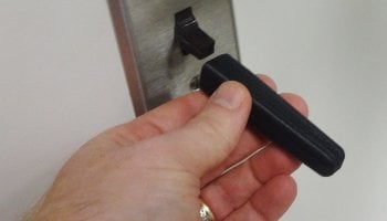 hand places a long extension on a light switch