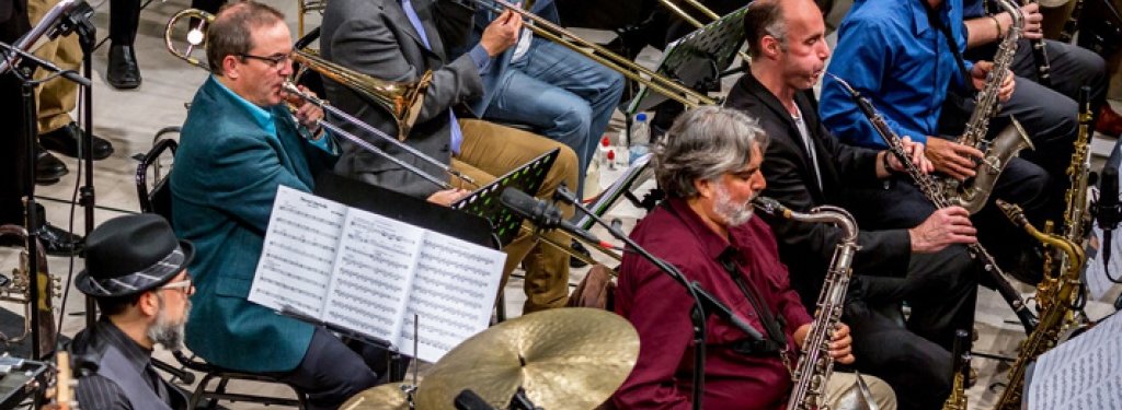 Mike Christianson (teal jacket playing trombone), an assistant professor in the Department of Visual and Performing Arts, performs with the John Hollenbeck (in hat) Large Ensemble. The band was nominated for a Grammy for their album 