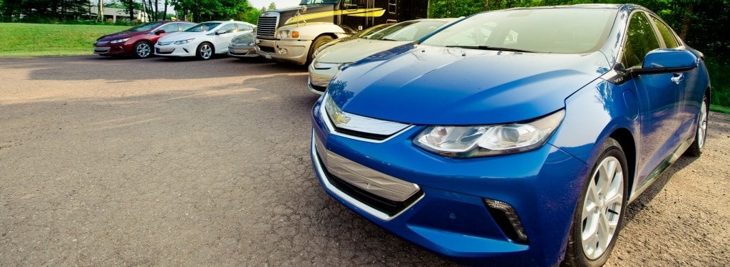 blue car in foreground in front of other cars