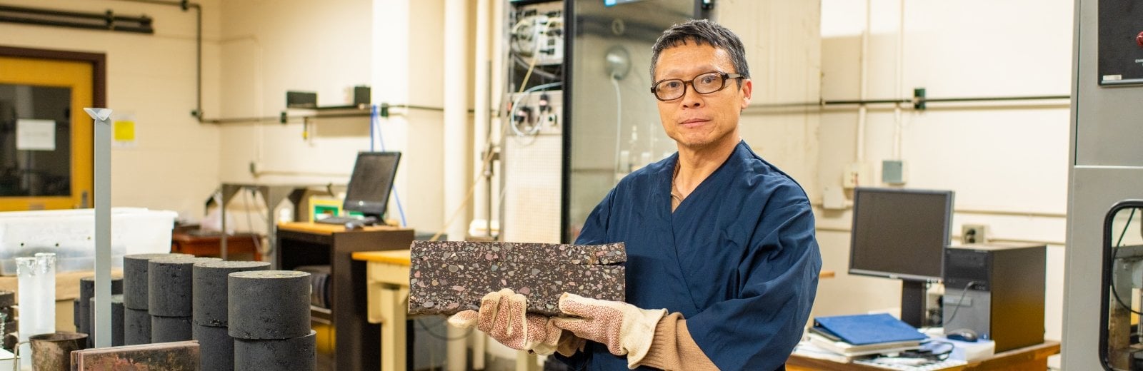 man holding a piece of asphalt