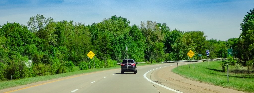 truck with a pole driving on a road