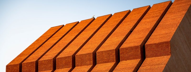 A close-up shot of the top floors of Michigan Tech's mechanical engineering building at sunset.