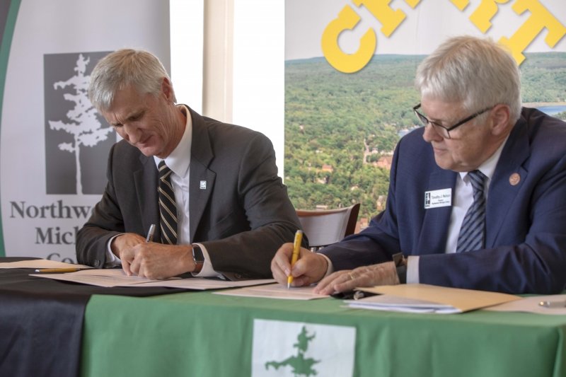 Michigan Tech President Rick Koubek and Northwestern Michigan College President Timothy J. Nelson sign articulation agreements.