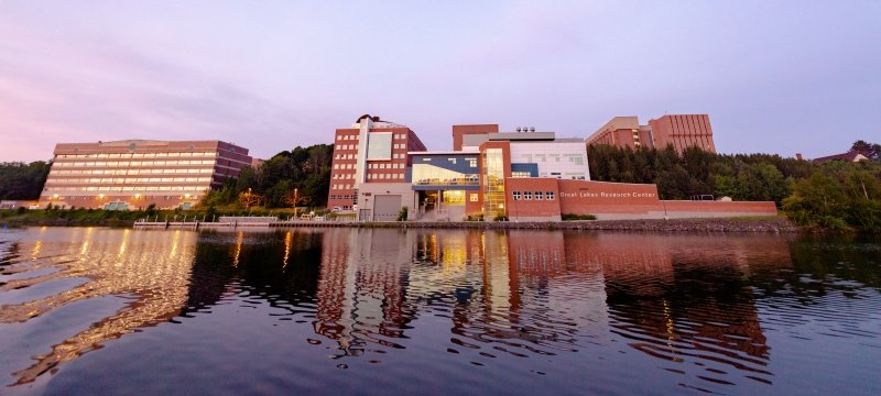 Michigan Tech's campus reflected in the Keweenaw Waterway.