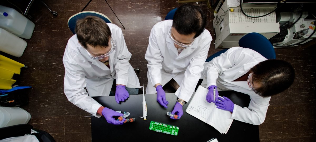 Stabilux Biosciences is a spin-off company of Michigan Tech that develops medical imaging technology. overhead shot of group of people in lab coats