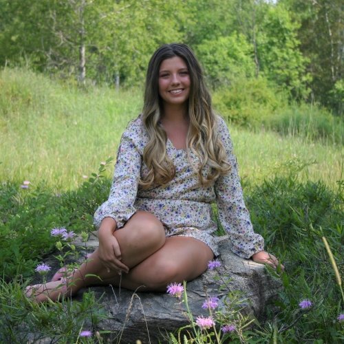 Ava Stoneberg sitting outside