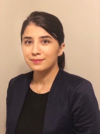 young woman smiling in suit coat