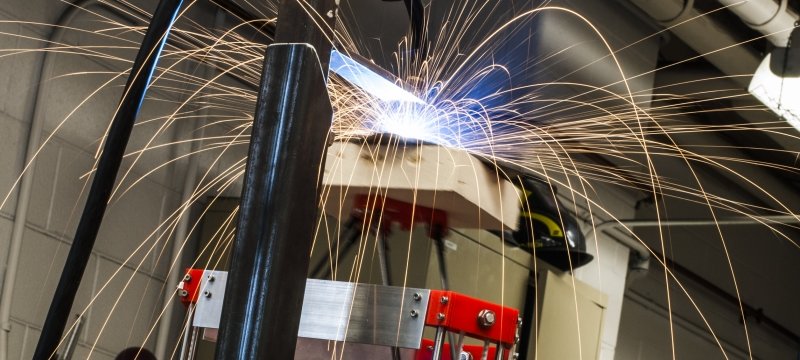 3D metal printer in an open source lab throwing sparks as it prints