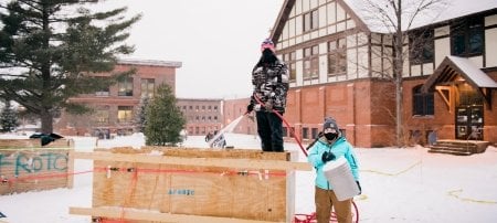 Members of Michigan Tech's Air Force ROTC, observing COVID-19 protocol, work on a statue for the month-long competition.