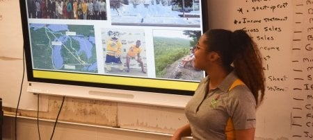 Andi Smith, vice president of Michigan Tech's student chapter of the National Society of Black Engineers presents to students in a Detroit school during the 2020 Alternative Spring Break.