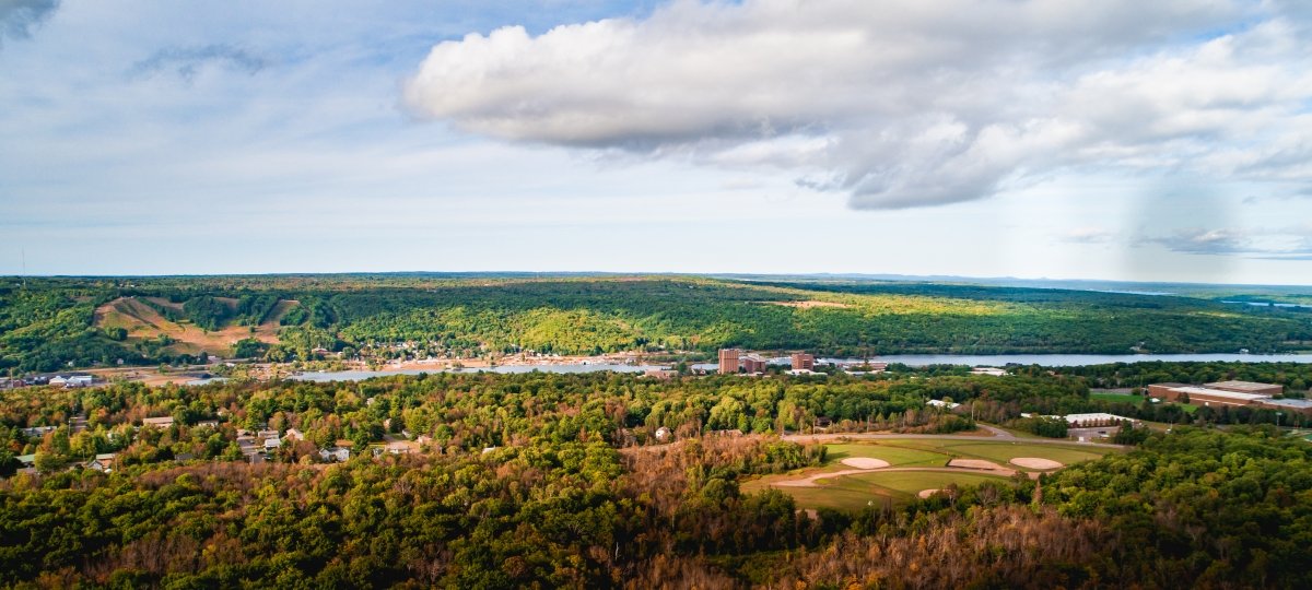 Drone image of Michigan Tech's campus, Keweenaw Waterway, and surrounding woods. 