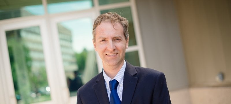 man smiling in a blue suit