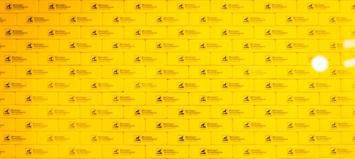 Old accounting processes rely on back-up records and third-party validations, which can take longer to work through. Blockchain’s built-in speed and transparency, which accounting prof Jun Dai works on, crosses Ts and dots Is more efficiently. Yellow blocks with the Michigan Tech husky logo stacked in neat rows