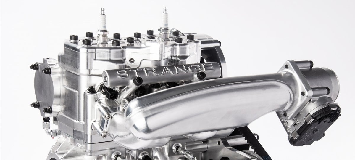 The REVolution engine uses a rotary exhaust valve (REV) to control emissions in a two-stroke engine while a supercharger ensures power and performance. Credit: Virginia Kamenitzer Ramsdell A small engine shines on a white background.