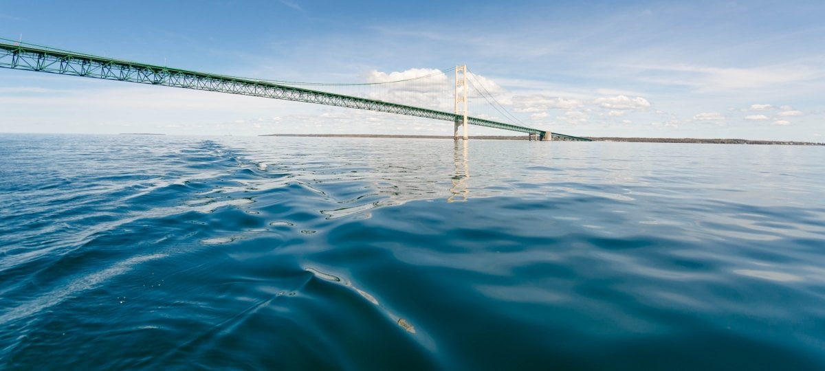 The Mackinac Bridge crosses the calm waters of the Straits of Mackinac.