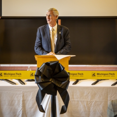 Michigan Tech President Rick Koubek speaks at a podium.