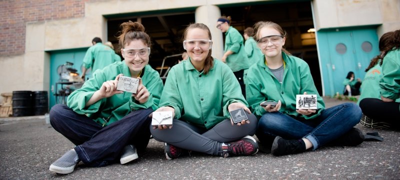 Three SYP participants hold their metal-working projects