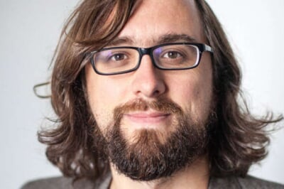 A man with a beard and glasses.