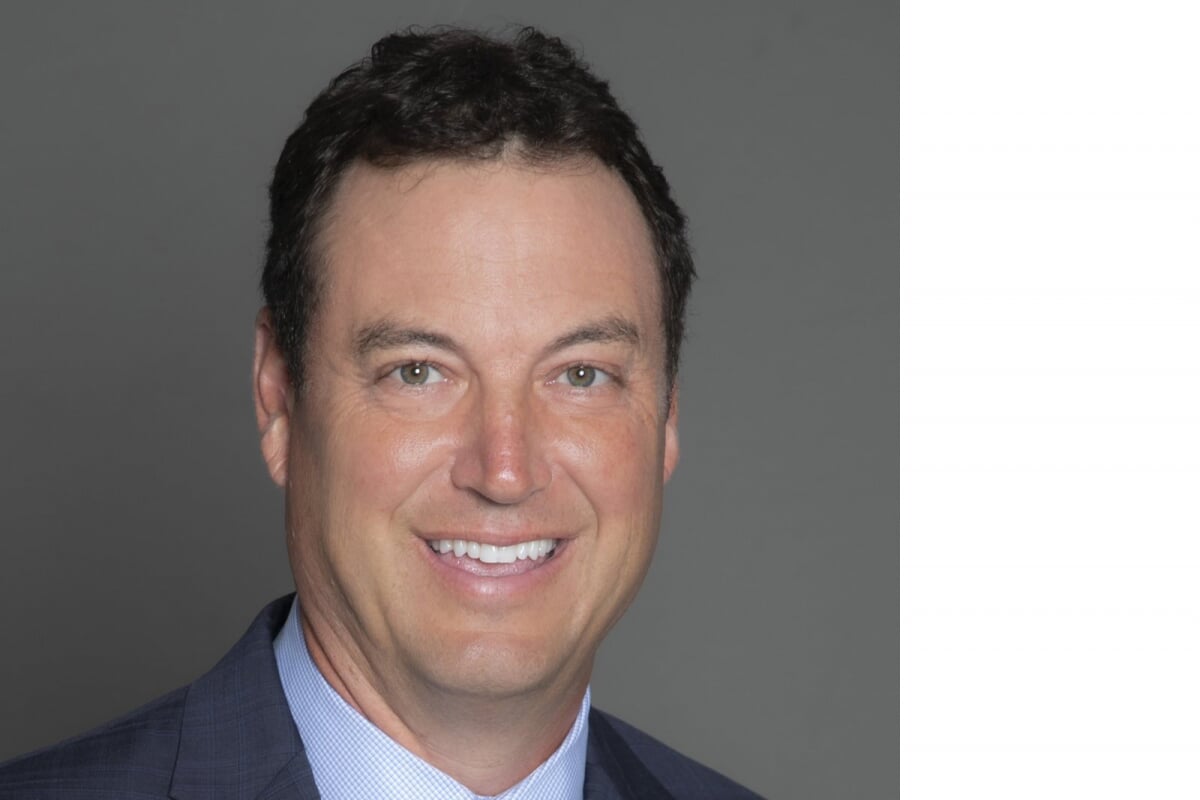 A man in a suit who is an MTU alumnus smiles in a portrait