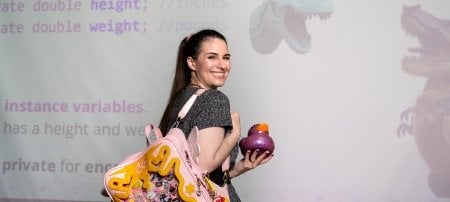 Briana Bettin with backpack duck and dinosaurs