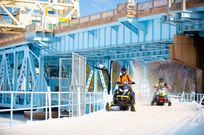 Snowmobiles on bridge