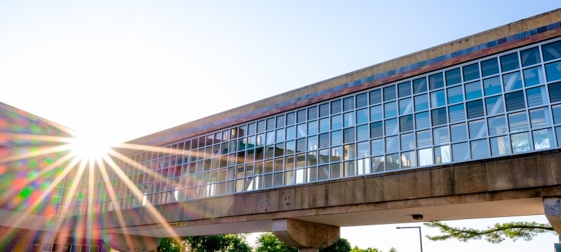 The glassed in walkway connecting the mineral and materials building from its main campus to lakeshore side.