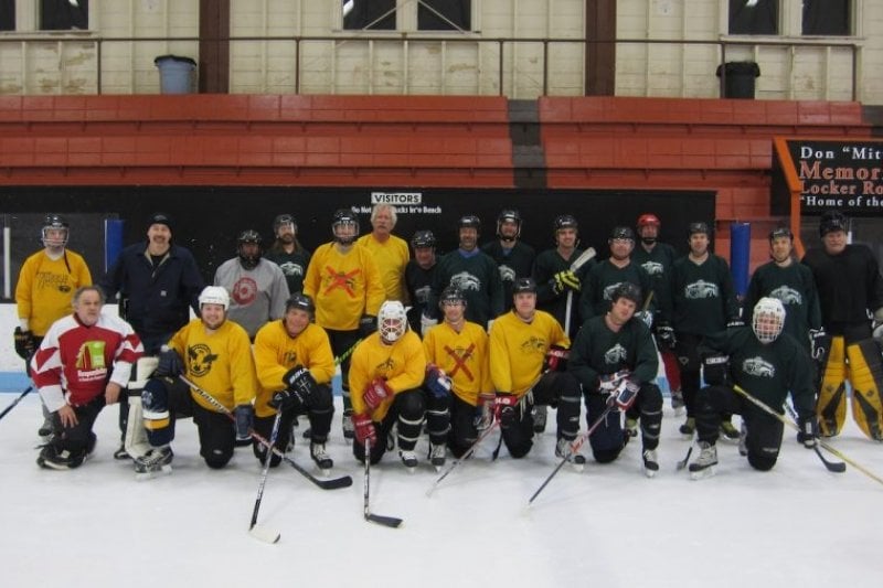 Goalie for Tech’s regular pick-up hockey team. Group shot of the pick-up hockey team in their gear on the ice.