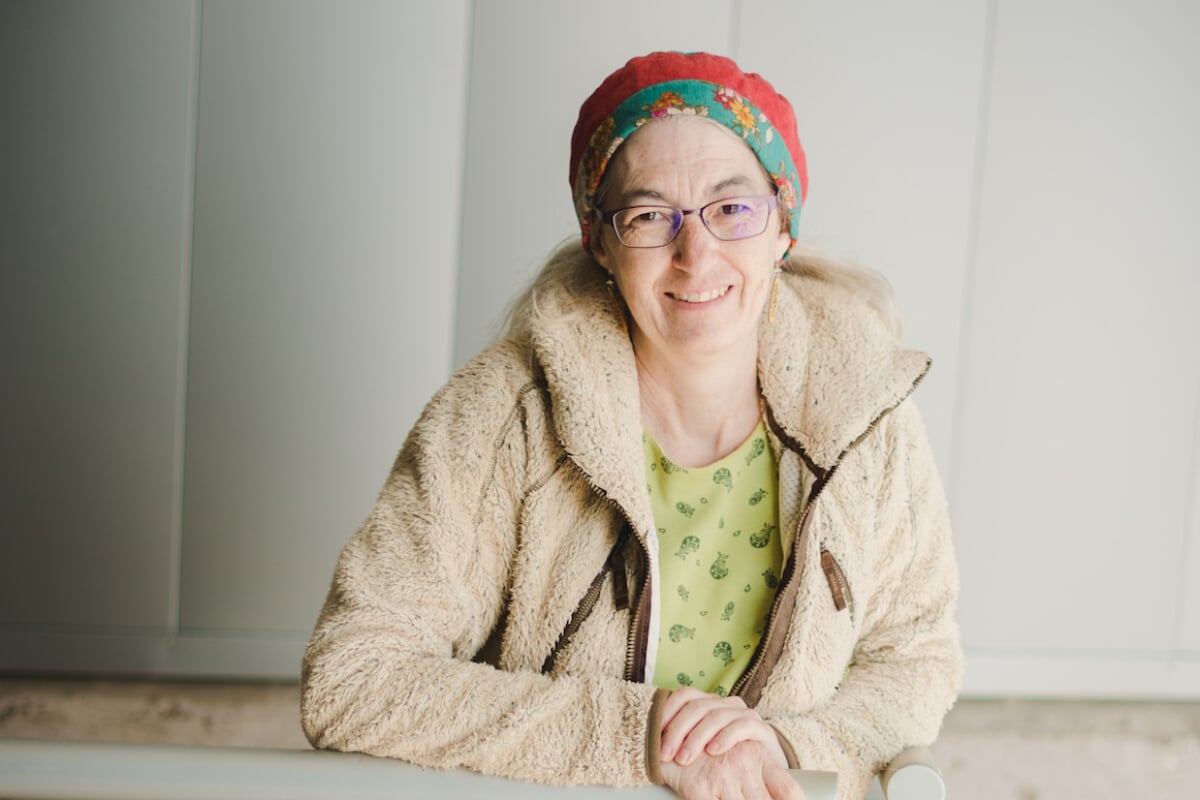 A scientist stands with her hands over the rail at the Great Lakes Research Center; she is leading a delegation to the UN climate change summit.