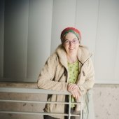 A scientist stands with her hands over the rail at the Great Lakes Research Center; she is leading a delegation to the UN climate change summit.