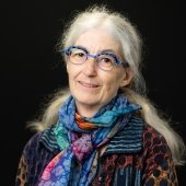 A chemist leading a Michigan Tech delegation to the UN Climate summit in a portrait wearing glasses and a colorful scarf.