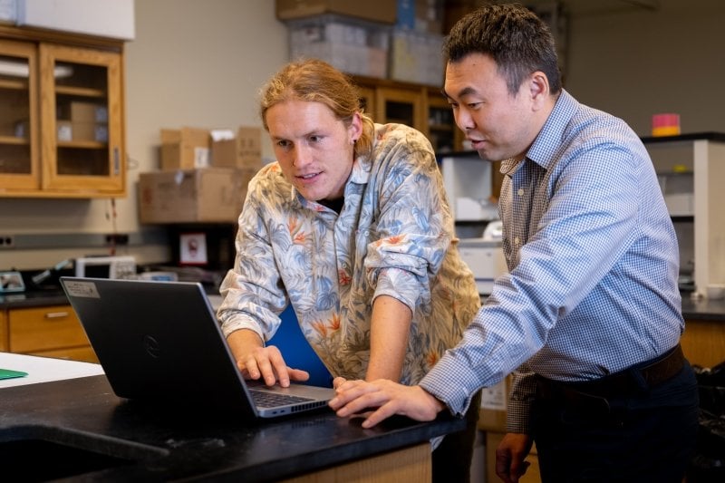 Two Michigan Tech researchers code an Intel Loihi Chip in a lab at Michigan Technological University in winter 2023.