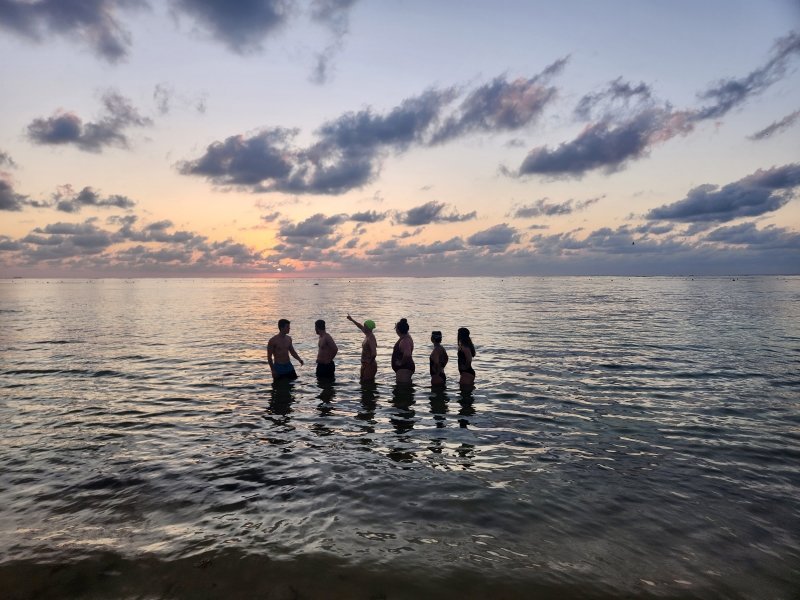 Six study abroad students stand in the ocean on the Yucatan Peninsula during a study abroad trip.