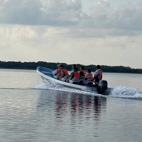 A boatload of Huskies and tour guides head out to a reef for snorkeling.