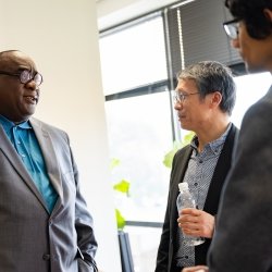 Three researchers from two universities discuss collaborations during a Michigan Tech visit to University of the District of Columbia