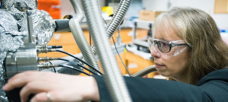 A researcher demonstrates her surface measurement technique in a Michigan Tech lab.