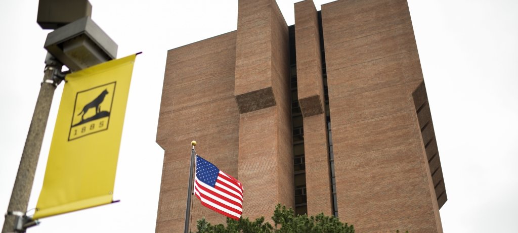 The Michigan Tech ME-EM building, with the Tech 1995 logo and an American flag in the foreground, is the center for a new national program run by the Department of Commerce offering $5.4 million in funding potential to support faculty and student researchers.