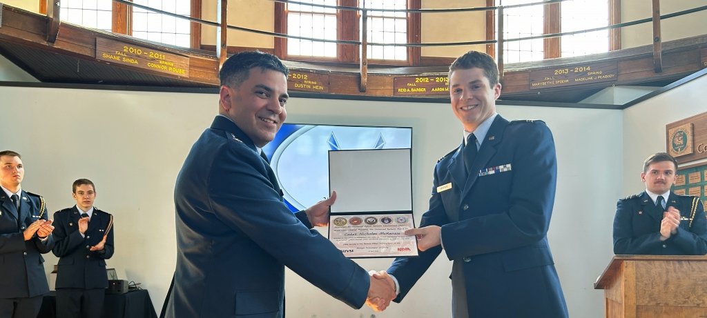 McKenzie receives the unmanned systems award from his commander, Lt. Col. Ben Zuniga, in the ROTC building at Michigan Tech. An Air Force ROTC cadet receives an unmanned systems award from his commander at Michigan Tech