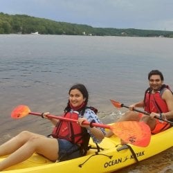 Tech's 2023 graduate student speaker for midyear commencement kayaks with friends near the waterfront campus.