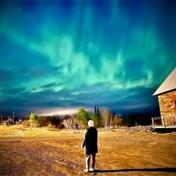 MTU's midyear commencement speaker for graduate students delights in the aurora borealis from a vantage at Quincy Mine near the campus.