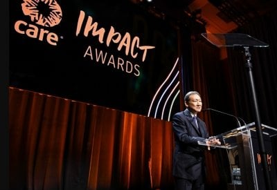 Chang K. Park accepts the Care philanthropic impact leadership award.