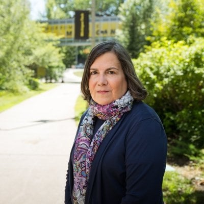 Jennifer Becker stands in front of the library on MTU's campus