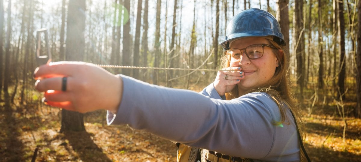 Forestry student Veronica Blissick spent her summer getting up close and personal with local wildlife during her internship with the Michigan Department of Natural Resources. Veronica Blissick uses an angle gauge to measure trees along the Tech Trails.
