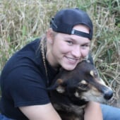 Brynn Santi hugging one of the mushing club dog.